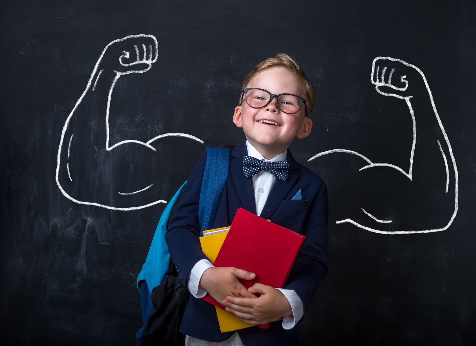 Child in glasses with books
