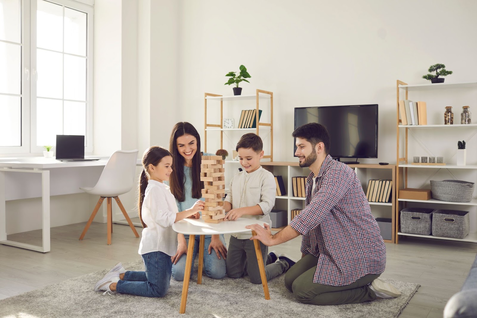 Evde masa oyunları oynayan çocuklu mutlu aile.